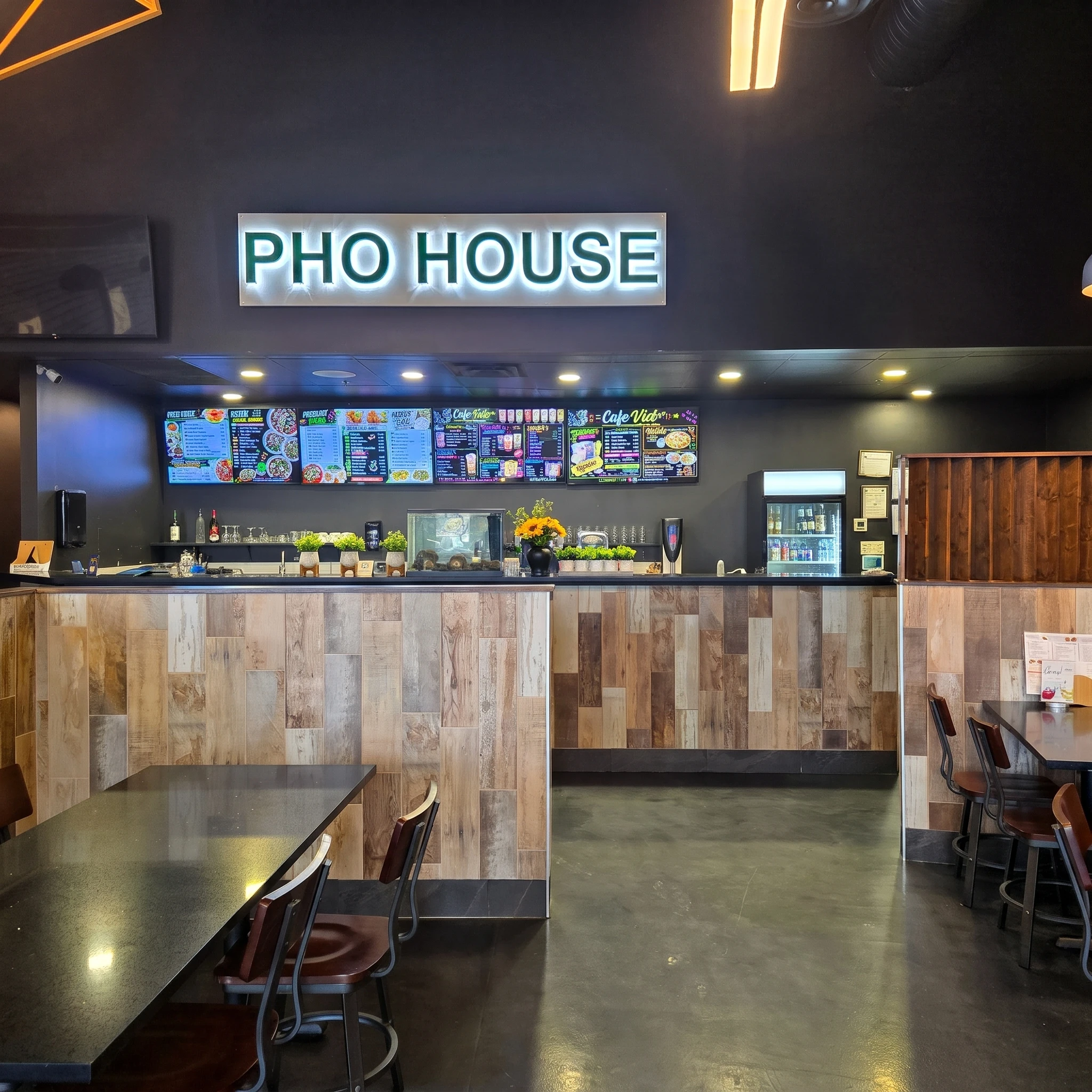 Order counter under the Pho House sign with menu boards at Pho House Chappelle