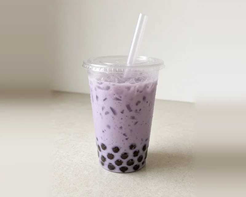 Taro bubble tea with tapioca pearls in a clear cup (illustrative image)